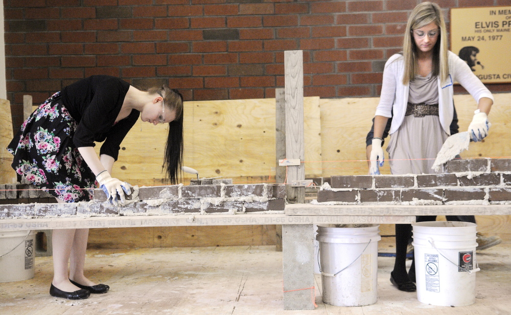 Waterville Senior High School senior Destiny Petit, left, and Madison Area Memorial High School junior Gretchen Miller assemble a brick wall Wednesday during the annual Jobs for Maine’s Graduates Career Development Conference in Augusta.