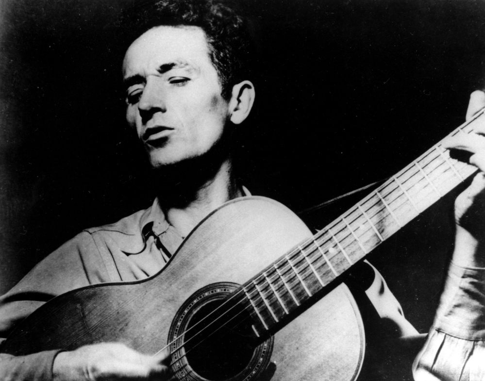 Eight guitars made from wood salvaged from Woody Guthrie's childhood home will be auctioned on eBay Thursday to benefit the rebuilding of the home.