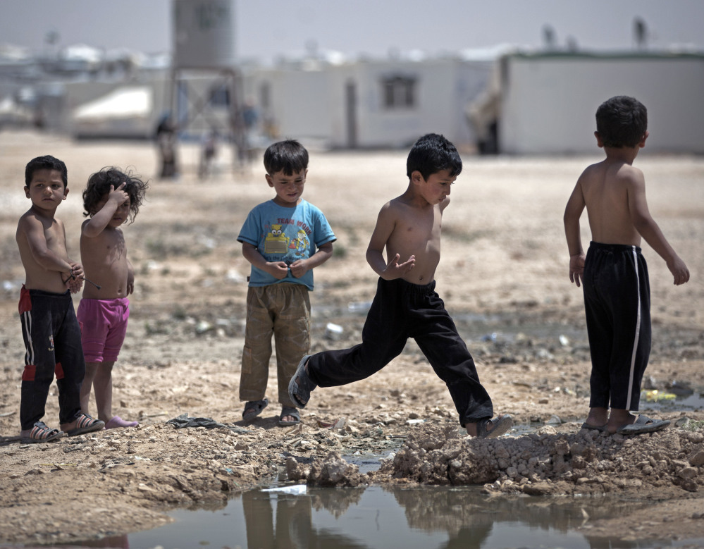 Syrian children play in the heat of the midday sun at Zaatari refugee camp, near the Syrian border in Jordan on April 17.