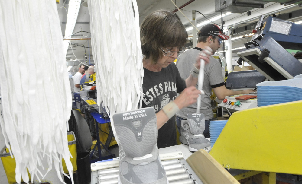 Sharon Estes inserts laces into shoes at New Balance’s Norridgewock factory in 2011. The U.S. military – which, for years, has flouted a law requiring the Pentagon to favor some American-made products – recently announced it will direct recruits to buy only American-made sneakers.