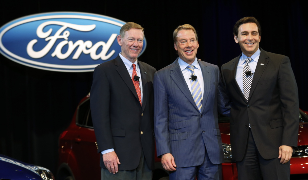 Ford Motor Co. President and CEO Alan Mulally, at left, stands with Executive Chairman Bill Ford Jr., middle, and Chief Operating Officer Mark Fields at a news conference in Dearborn, Mich., on Thursday. Mulally, who in 2006 was an industry newcomer from Boeing, helped lead the auto company through a massive and painful turnaround.