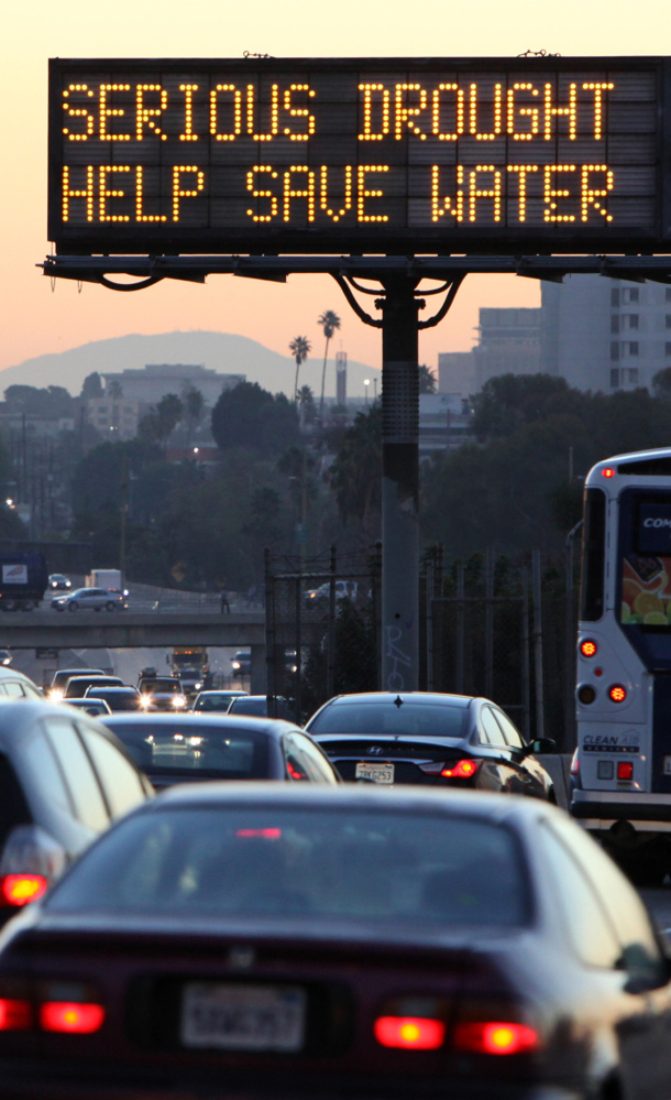 A sign reminds drivers in Los Angeles to conserve water as California faces a withering drought.