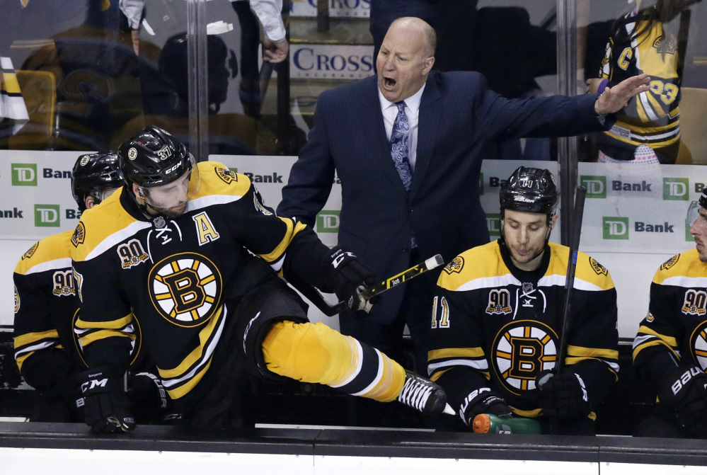 Boston Bruins head coach Claude Julien, center, yells as center Patrice Bergeron climbs over the boards to face the Montreal Canadiens during the third period of Game 1 in the second round of the Stanley Cup playoff series in Boston on Thursday.