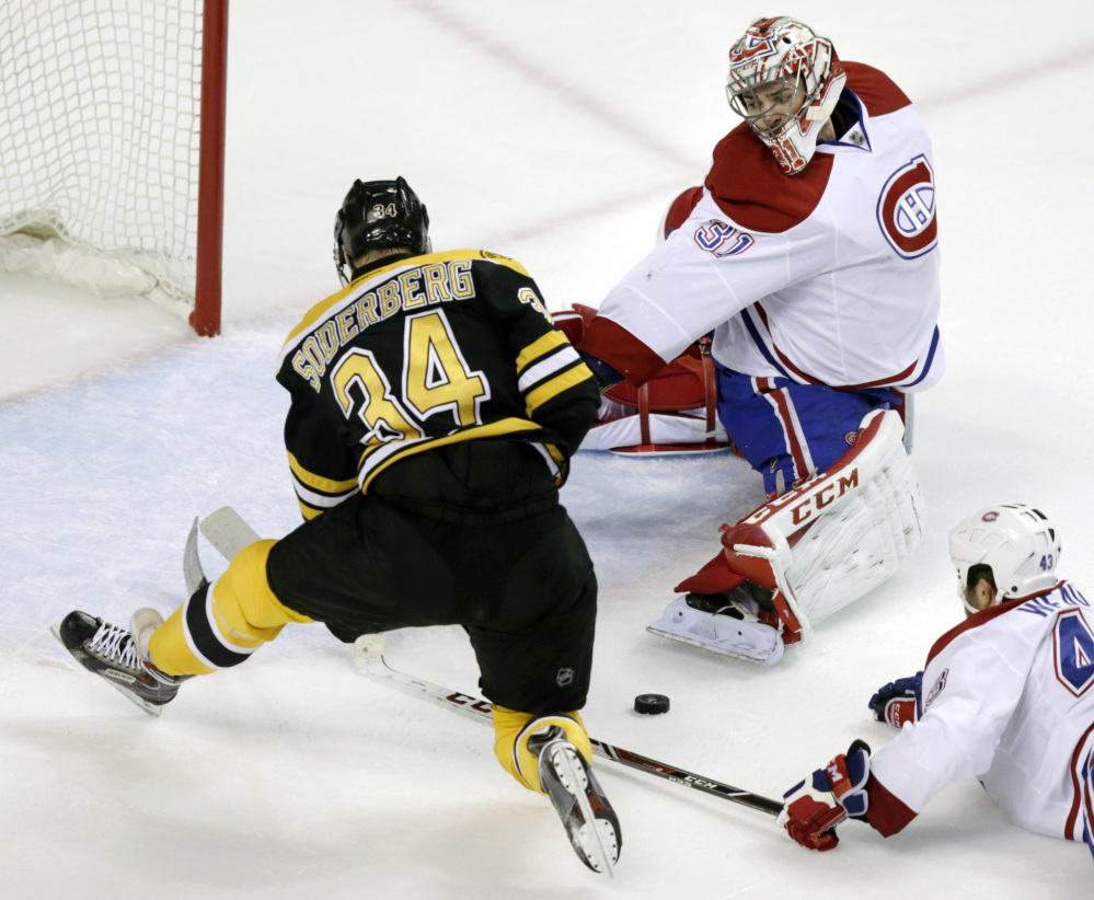 Montreal Canadiens goalie Carey Price reaches back to make a save on a shot by Boston Bruins center Carl Soderberg during the second period Thursday.