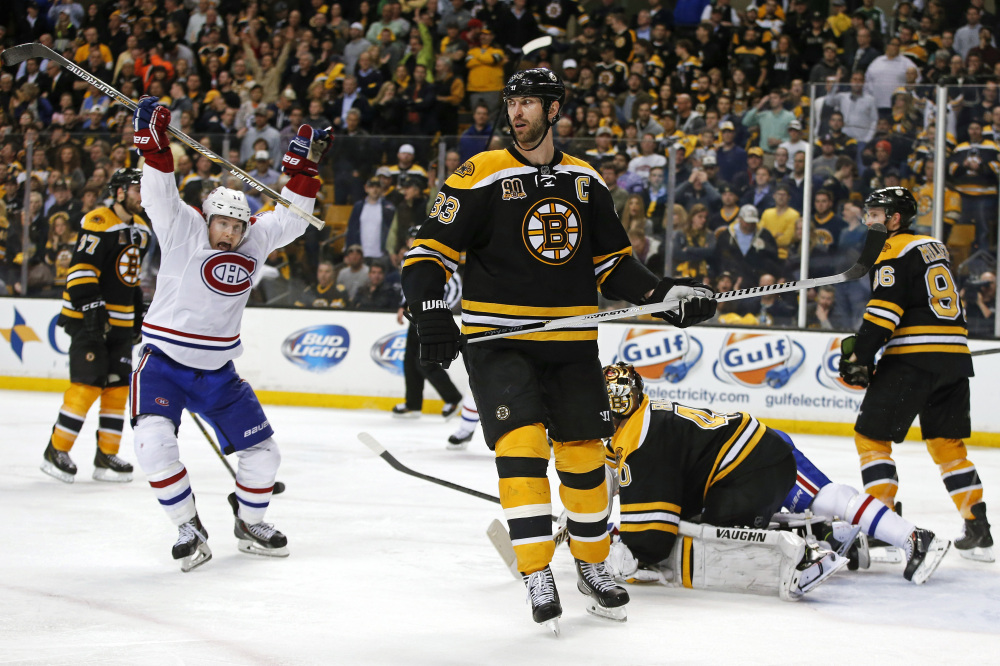 Montreal Canadiens right wing Brendan Gallagher celebrates his teammate P.K. Subban’s game-winning goal in the second overtime period as Boston Bruins defenseman Zdeno Chara (33) skates past in Game 1 of the second-round Stanley Cup playoff series in Boston on Thursday.