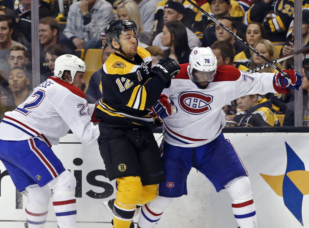 Boston Bruins right wing Jarome Iginla, center, grapples along the boards with Montreal Canadiens right wing Dale Weise and defenseman P.K. Subban on Thursday in Boston.