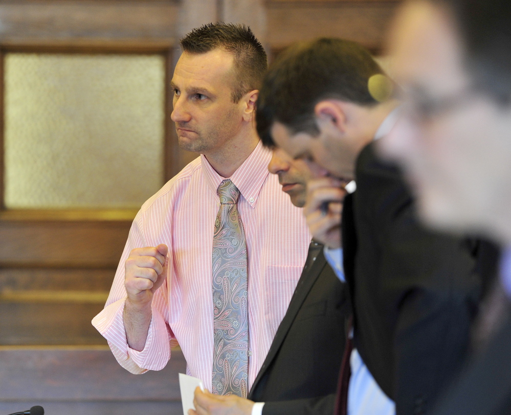 Joshua Nisbet questions a witness in his robbery trial on Monday as two standby attorneys quietly give him advice. He may be the first defendant in Maine to have been ordered to defend himself.