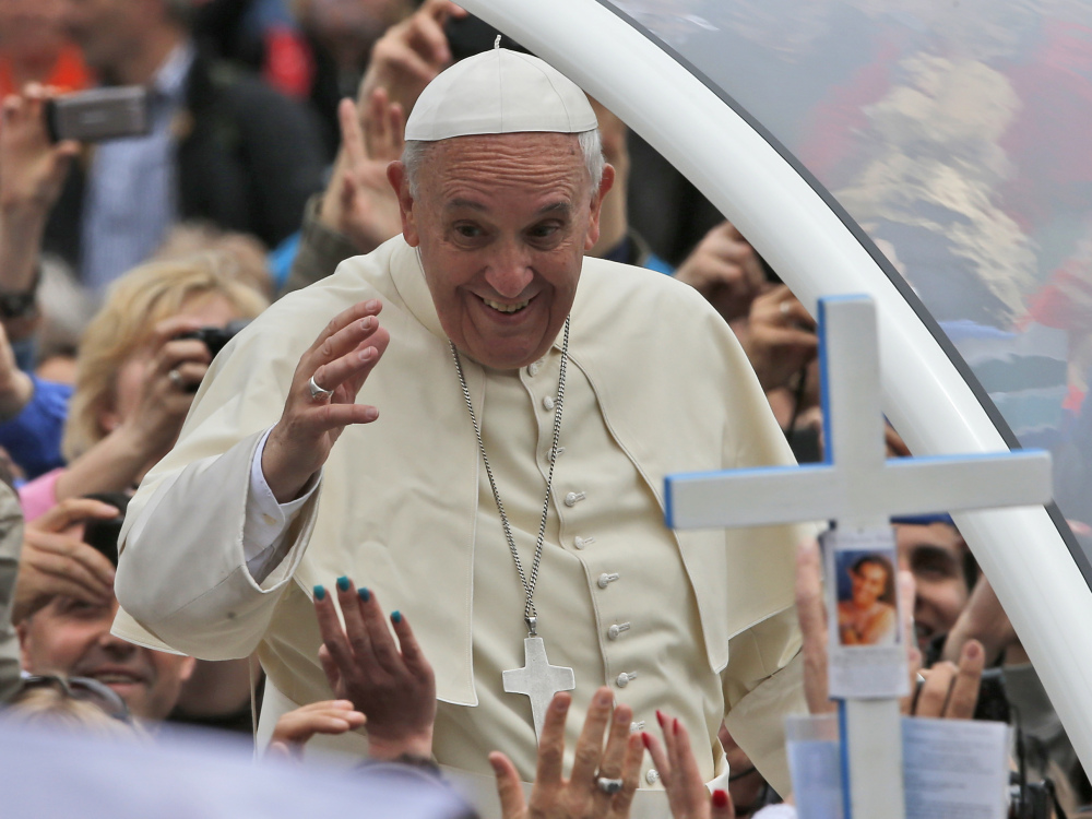 Pope Francis waves to the faithful as he is driven through the crowd after presiding over a solemn ceremony in St. Peter’s Square at the Vatican on Sunday. He plans to convene an ‘extraordinary’ synod of bishops to review and debate teachings.