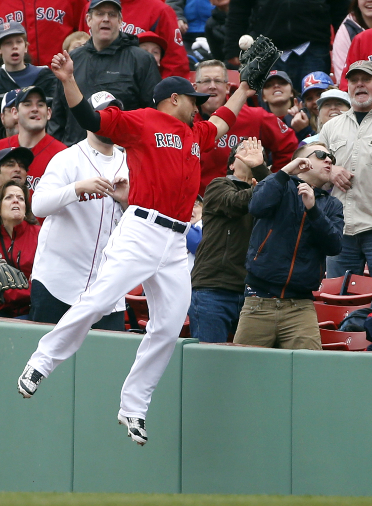 Boston Red Sox right fielder Shane Victorino jumps but cannot catch a fly that fell foul in the fourth inning in the first game of a doubleheader at Fenway Park on Thursday. The fly was hit by Rays right fielder Wil Myers.