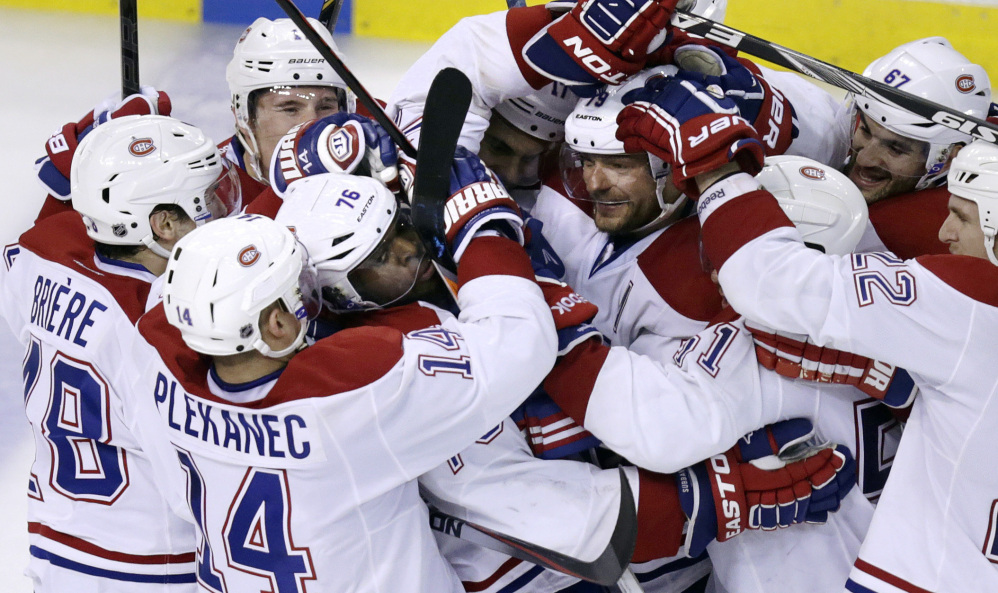 Canadiens defenseman P.K. Subban (76) is surrounded by teammates after scoring the game-winning goal off Boston Bruins goalie Tuukka Rask during the second overtime period of Game 1 Thursday. The Canadiens won 4-3.