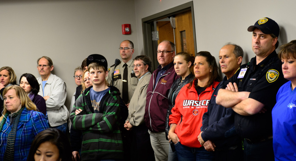 Students, parents and community members listen as Waseca Police Capt. Kris Markeson and Waseca school Superintendent Tom Lee speak about the 17-year-old arrested in a plot to kill his family and massacre students.