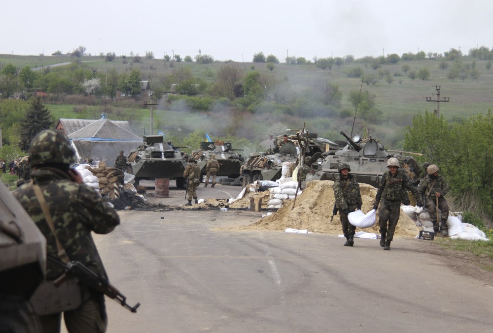 Ukrainian government troops strengthen their position at a checkpoint just outside Slovyansk, eastern Ukraine, Friday.