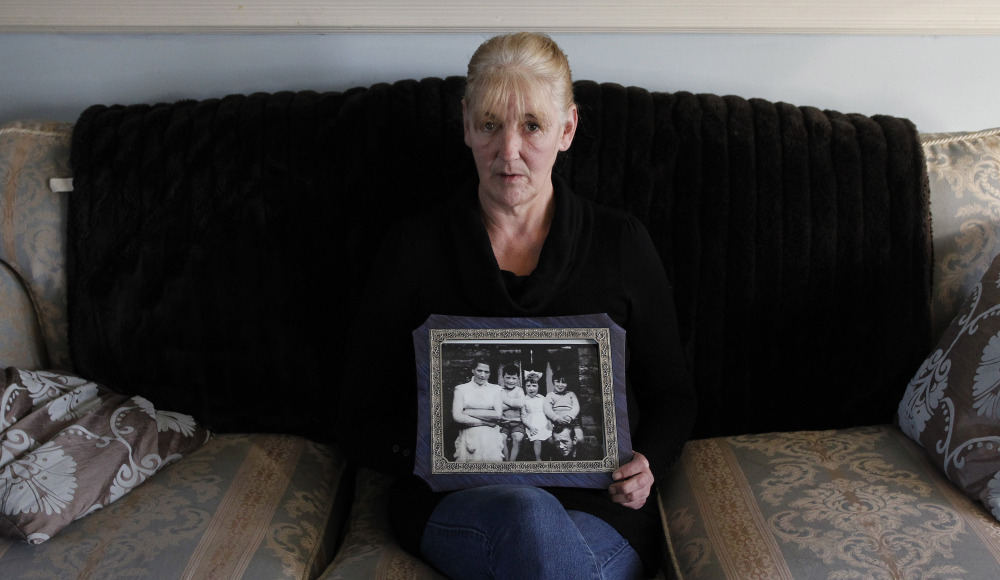 Helen McKendry holds a family photograph showing her mother, Jean McConcille, at home in Killyleagh, Northern Ireland. She has long sought an Irish Republican Army admission of responsibility in her mother’s death and help in finding her remains.