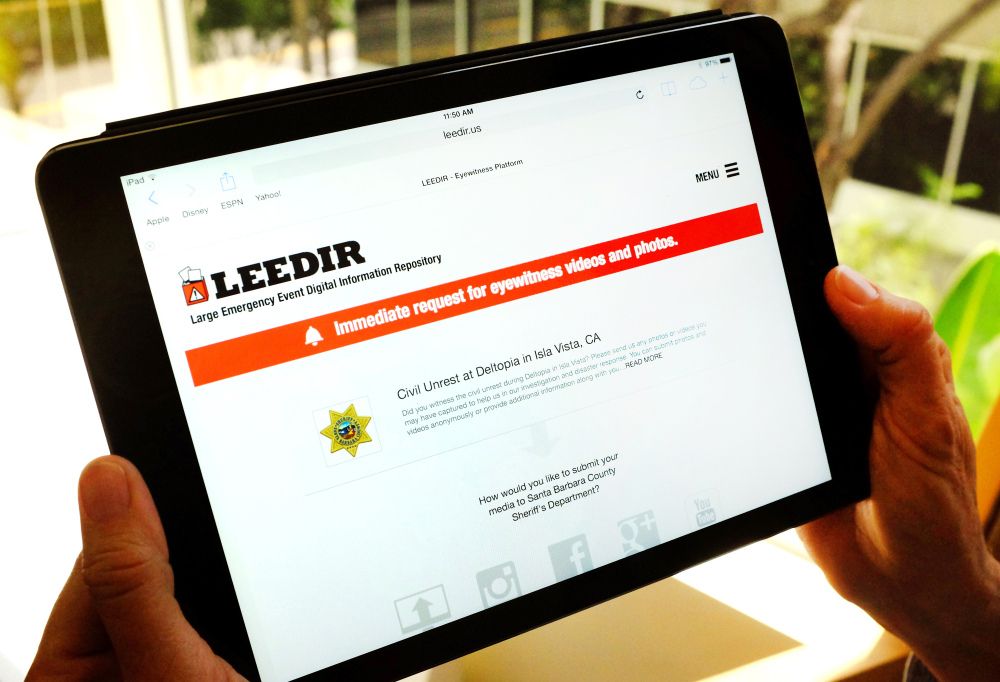 A computer tablet displays a website for LEEDIR, or the Large Emergency Event Digital Information Repository, that aims to make use of a document-everything culture evident on Instagram, Facebook and other social media to benefit law enforcement nationwide.