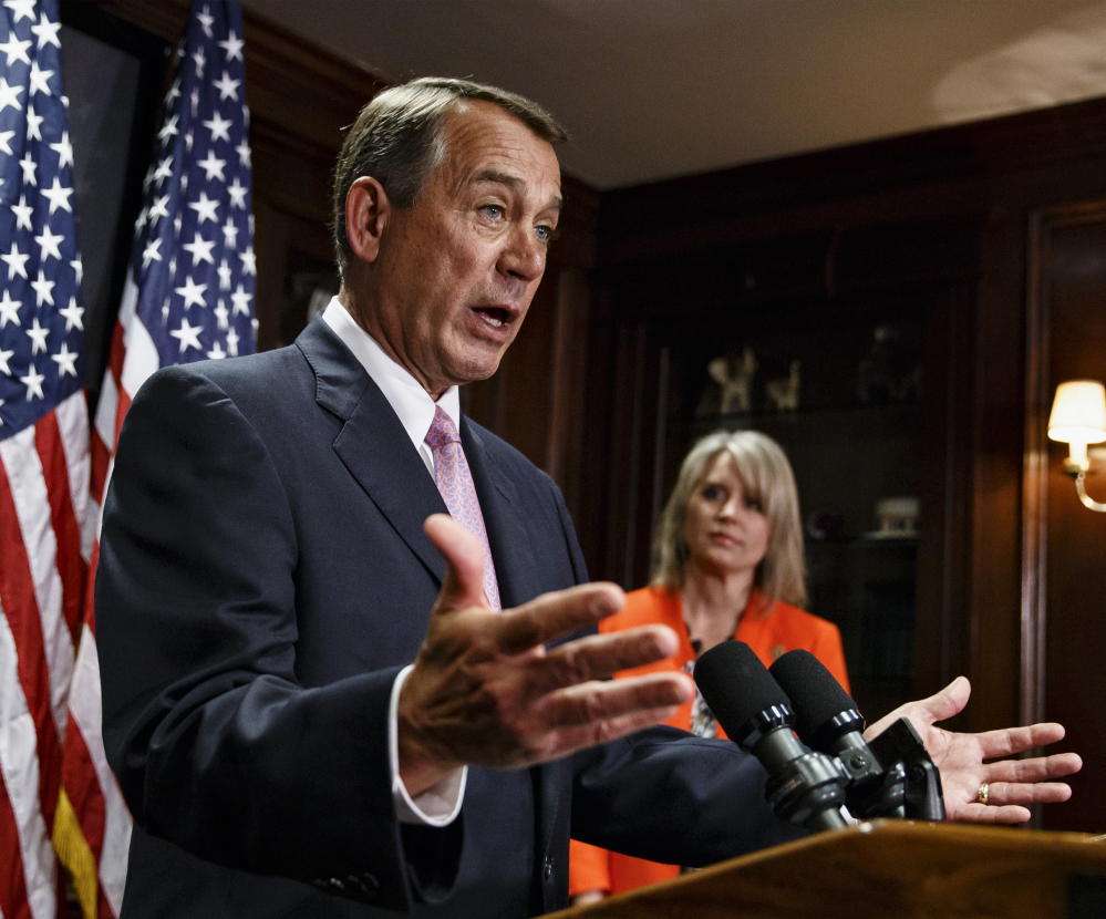 House Speaker John Boehner, joined by Rep. Renee Ellmers, R-N.C., talks to reporters after a Republican strategy meeting Tuesday in Washington.
