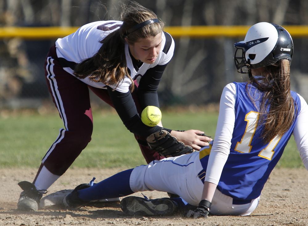Bailey Karnes of Freeport attempts to control the ball Friday as Amanda Carver of Falmouth slides safely into second base during Falmouth’s 17-0 victory in softball.