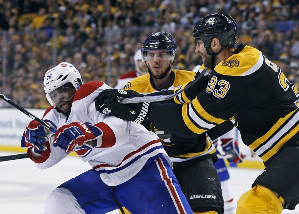 Zdeno Chara tries to move Montreal’s P.K. Subban off the puck as Bruins center David Krejci, middle, looks on during the second period in Game 2 Saturday in Boston.