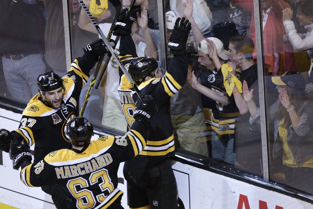 Reilly Smith, 18, of the Bruins celebrates his goal against the Canadiens during the third period of Game 2 in the second round of the playoffs in Boston Saturday. The Bruins won 5-3, tying the best-of-seven games series at one game each. At left are Patrice Bergeron, 37, and Brad Marchand.