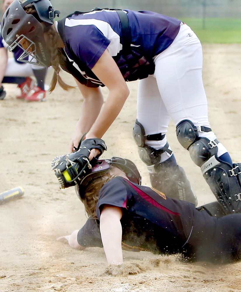Cape Elizabeth’s Michaela Pinette slides under the tag of Fryeburg catcher Mikayla Cooper to score a run in the fourth inning. Pinette scored two runs to help the Capers improve to 5-0.