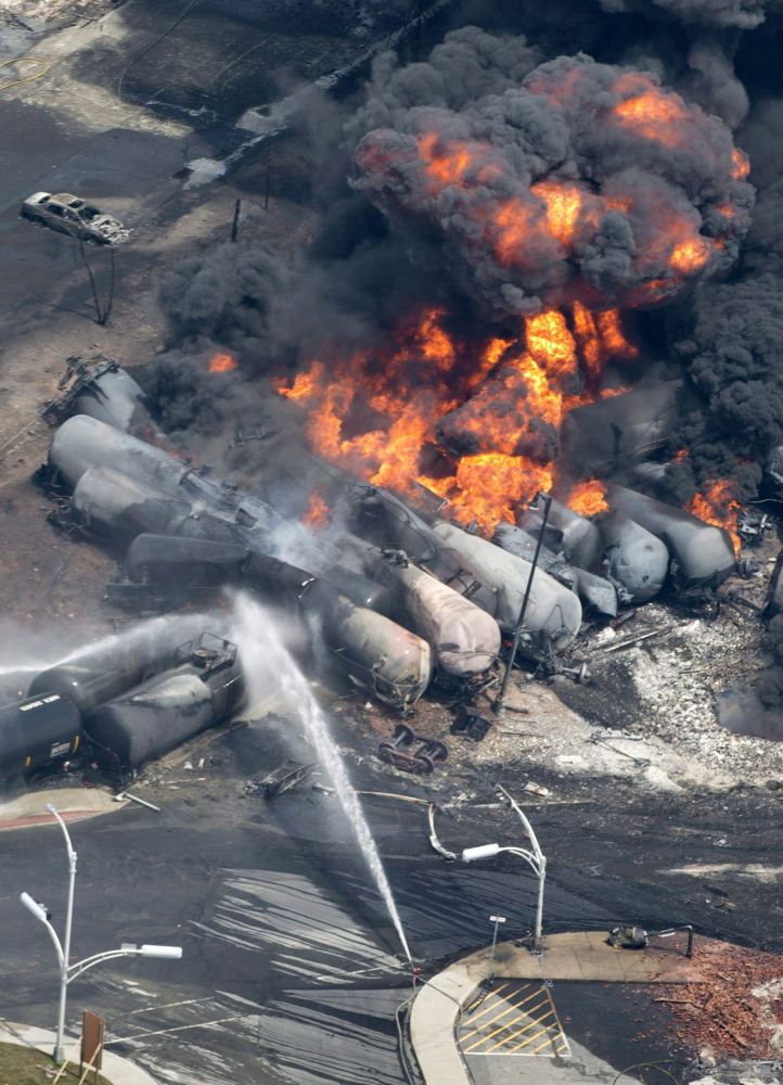 Smoke rises after railway cars carrying crude oil derailed in Lac-Megantic, Quebec, on July 6, killing 47 people.