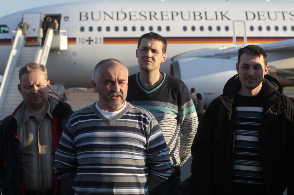 Some of the OSCE monitors who were released by Ukrainian insurgents Saturday take part in a briefing at Boryspil airport outside Kiev. The pro-Russia insurgent leader in Slovyansk was quoted as saying he ordered the release because of increasing insecurity in the city.
