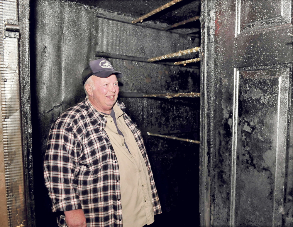 Dave Dutton stands inside a smoke room at his home in Vassalboro where he smokes alewives and other kinds of meats. He plans to enter an alewife chowder cook-off during the Benton Alewife Festival in May.