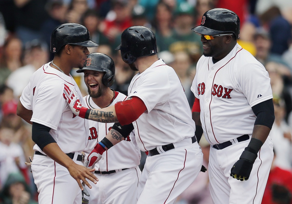 Boston Red Sox’s Jonny Gomes, center, celebrates his grand slam that also drove in, from left, Xander Bogaerts, Dustin Pedroia and David Ortiz in the first inning against the Oakland Athletics in Boston on Saturday.