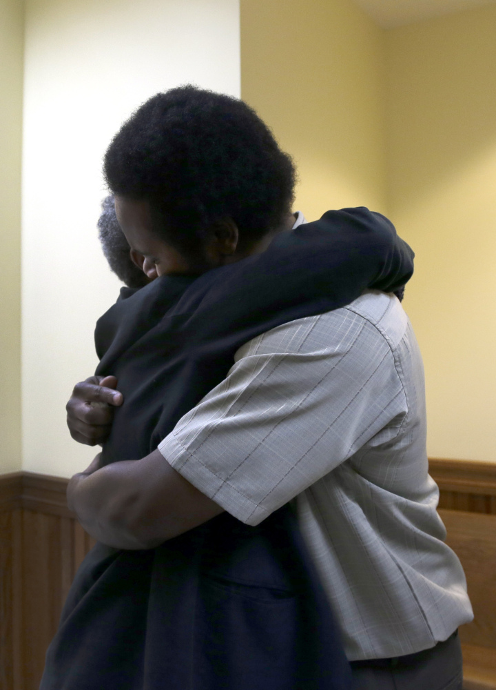 Cornealious "Mike" Anderson gets a hug from his grandmother Mary Porter after being released from custody on Monday.
