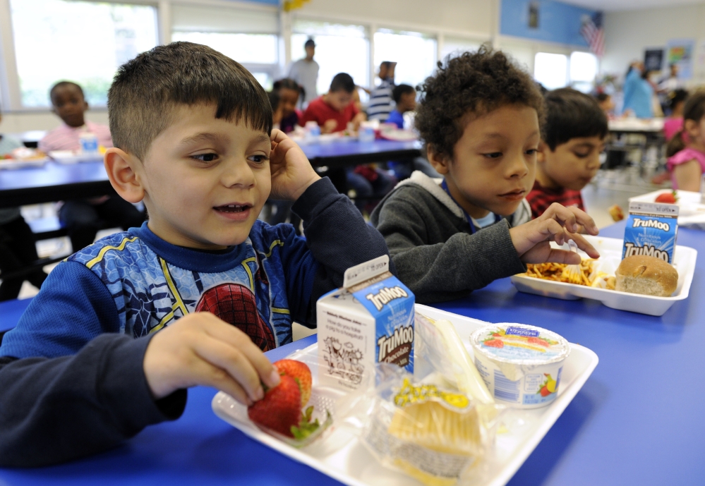 Biden Arias-Romers, 5, left, and Nathaniel Cossio-Boatwright, 6, eat lunch at the Patrick Henry Elementary School in Alexandria, Va. Starting next school year, pasta and other grain products in schools will have to be over half whole grain.
