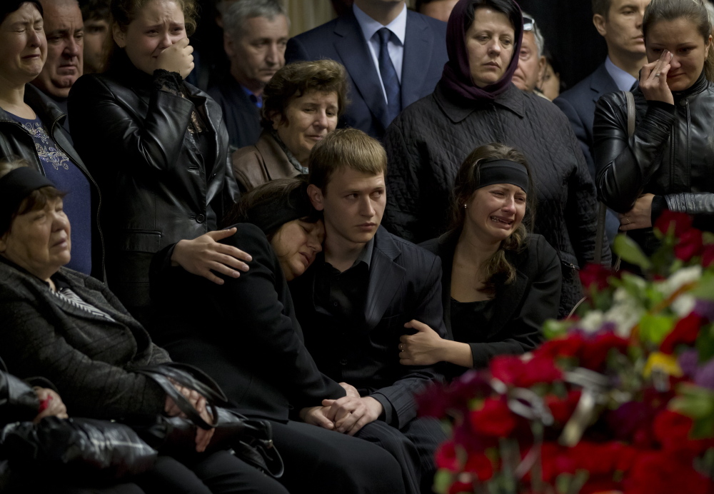 Mourners cry next the coffin of regional parliament member Vyacheslav Markin in Odessa, Ukraine, on Monday. Markin, who was known for speaking out against the government in Kiev, was buried Monday while about 300 pro-Russian supporters shouted “Hero, hero!” Markin died Sunday from burns sustained in Friday’s fire.