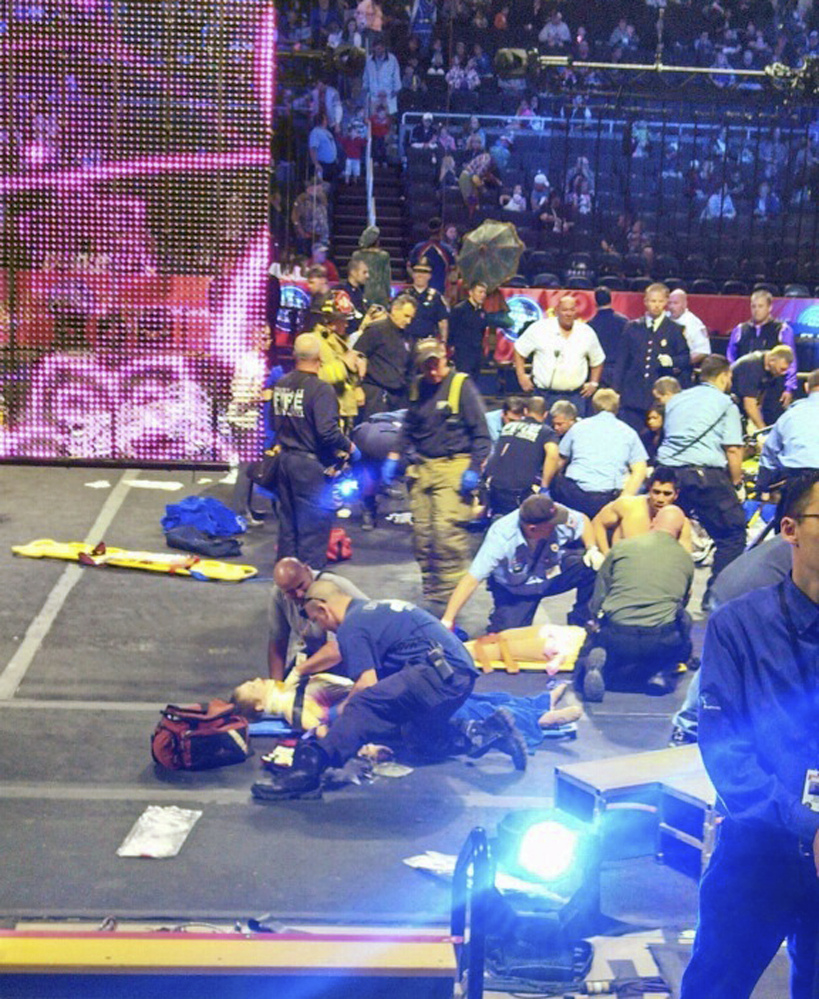 In photo by circus-goer Rosa Viveiros, first responders work at the center ring after a platform collapsed during an aerial hair-hanging stunt at the Ringling Brothers and Barnum & Bailey Circus on Sunday in Providence, R.I. At least nine performers were seriously injured.