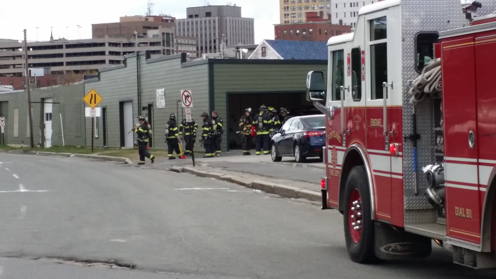 Portland firefighters investigate a gas leak near Marginal Way and Forest Avenue on Monday morning.