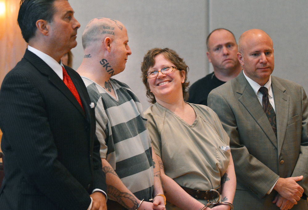 Jeremy Lee Moody and his wife Christine smile at each other before they were both sentenced to life in prison on Tuesday, May 6, 2014, in Union, S.C. Authorities say Jeremy and Christine Moody killed 59-year-old Charles Parker and his 51-year-old wife Gretchen Parker last July, stabbing and shooting them. Investigators say the Moodys are members of a loosely organized online white supremacist group called Crew 41 and decided to kill Parker because he had taken advantage of a disabled woman. (AP Photo/Spartanburg Herald-Journal, Tim Kimzey)