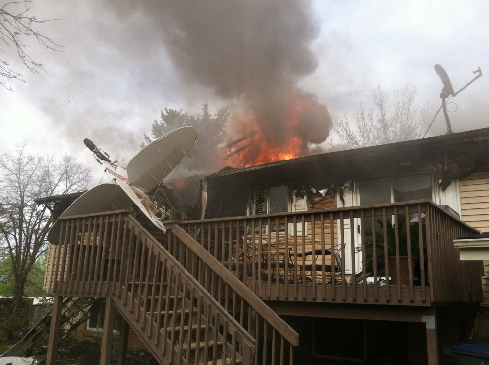 This photo provided by North Metro Fire Rescue District shows a house on fire after a plane crashed into it in Northglenn, Colo., Monday. The pilot, Brian Veatch, once owned the home, as indicated by property records. Veatch tried to put out the fire with a garden hose before he was forced away by burning fuel.