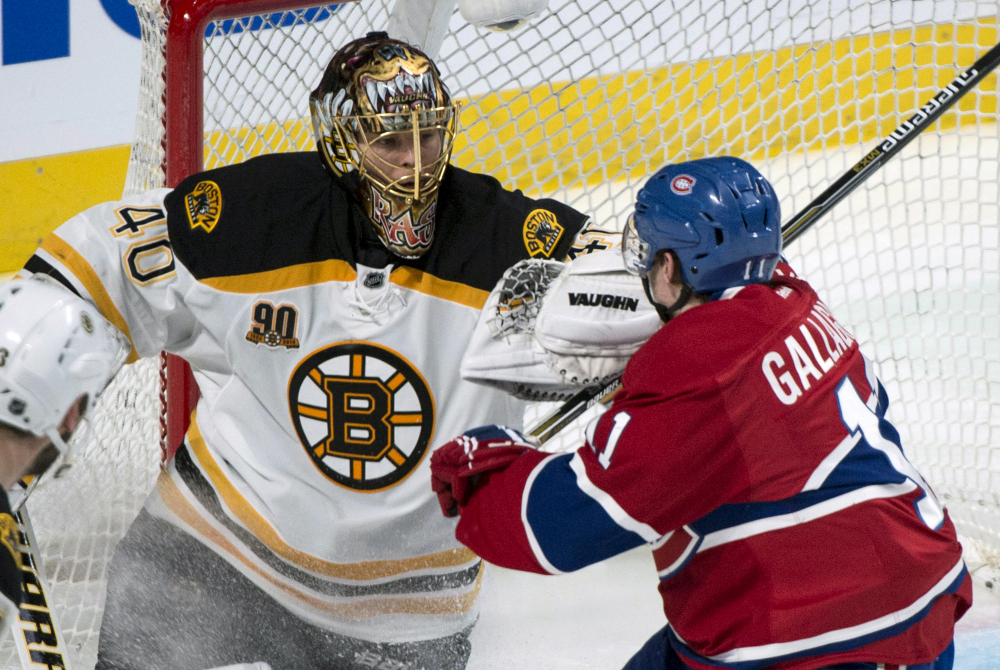 Boston Bruins goalie Tuukka Rask fends off Montreal Canadiens’ Brendan Gallagher, right, during second period of Game 3 of an NHL hockey Stanley Cup playoff series, Tuesday, May 6, 2014, in Montreal.