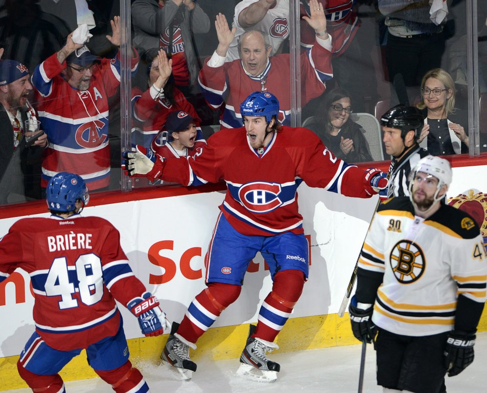 Montreal Canadiens right wing Dale Weise (22) celebrates his goal with teammate center Daniel Briere (48) as Boston Bruins defenseman Andrej Meszaros (41) looks on during the second period of Game 3 of an NHL hockey Stanley Cup playoff series, Tuesday, May 6, 2014, in Montreal.