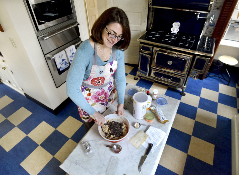 Susan Giambalvo, program director for the Center for Grieving Children, makes cookies in the kitchen of a gracious home on the Western Prom in Portland that will be included in the Portland Kitchen Tour. The center is the beneficiary of this year’s tour.