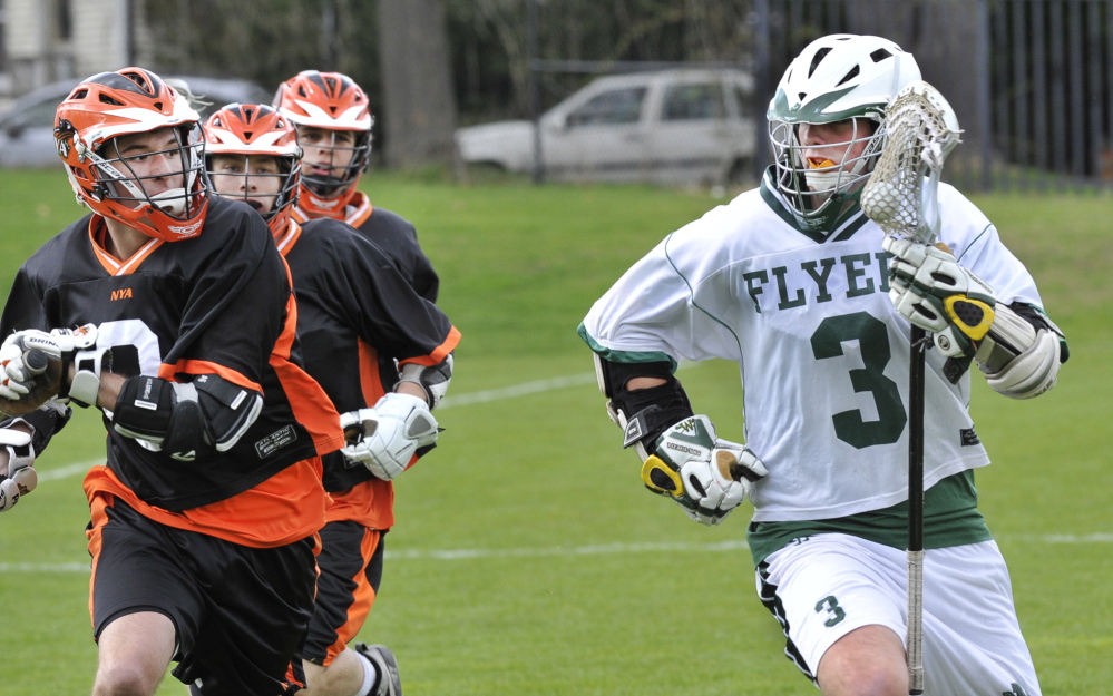 Henry Cleaves, who scored three goals for Waynflete, is pursued by an NYA group that includes Colton Ackerman, left. The Flyers improved to 3-1 and dropped the Panthers to 0-4.