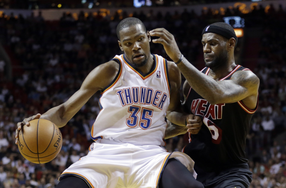In this Jan. 29, 2014 file photo, Miami Heat small forward LeBron James (6) puts pressure on Oklahoma City Thunder small forward Kevin Durant (35) during the fourth period of an NBA basketball game in Miami.
