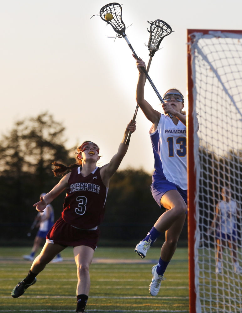 Julia Spugnardi of Falmouth attempts to receive a pass while defended by Lizzy Martin of Freeport at Falmouth High.