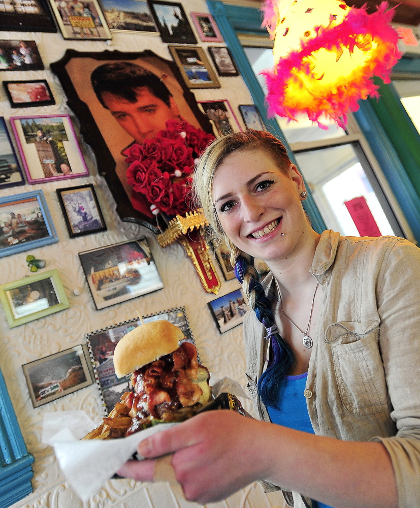 Surrounded by Silly’s signature quirky art, hostess Callie Steinberg shows off a specialty cheeseburger called Bleu Swayed ’Cue, made with two charbroiled hand-formed beef patties, pickles, cheddar, barbecue sauce, bacon, caramelized onions and blue cheese crumbles, with fries.