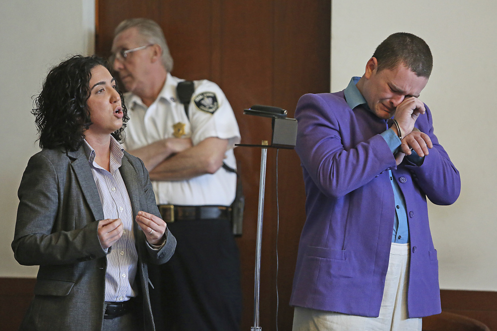 Kevin Edson cries during a hearing as he stands beside his attorney, Shannon Lopez, left, in Municipal Court Wednesday in Boston. Edson, accused of a bomb hoax near the Boston Marathon finish line on the anniversary of the 2013 bombing anniversary, was found mentally competent for trial after being evaluated at a state hospital following his April 15 arrest.