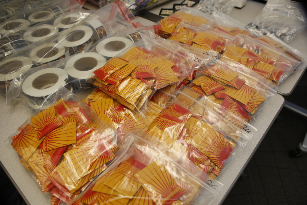 Confiscated synthetic drugs are on display at a news conference at the DEA offices in Centennial, Colo., on Wednesday, where it was announced that a federal grand jury in Denver has returned indictments charging nine individuals from across the country with conspiracy and drug distribution charges related to “Spice.”