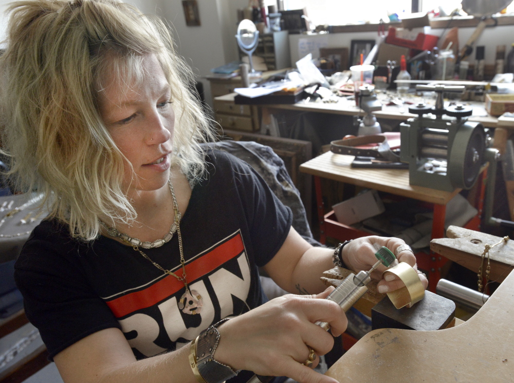 Hannah Tarkinson, seen polishing a bracelet at her Portland studio, is an avowed supporter of Creative Portland’s efforts. “I love that Portland is trying to bring people together and connect them,” she said.