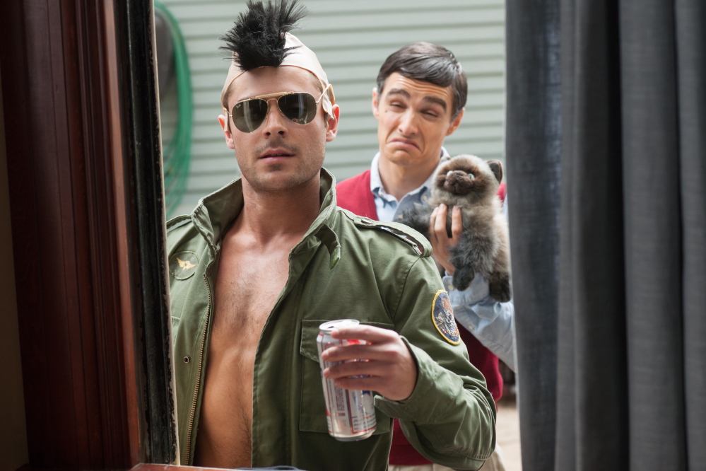 The comedy also stars Zac Efron, left, and Dave Franco as frat boys next door.