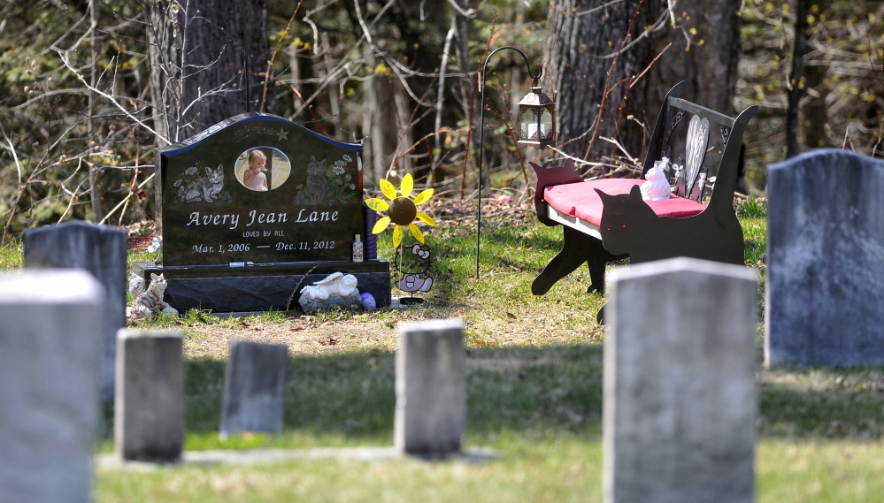 Decorations at the grave site of 6-year-old Avery Lane, shown Thursday, have been restored since the site was vandalized recently.