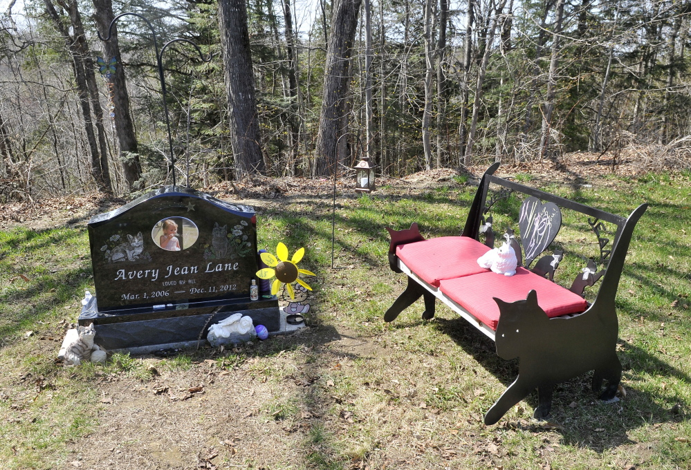 Decorations at the grave site of 6-year-old Avery Lane, shown Thursday, have been restored since the site was vandalized recently.