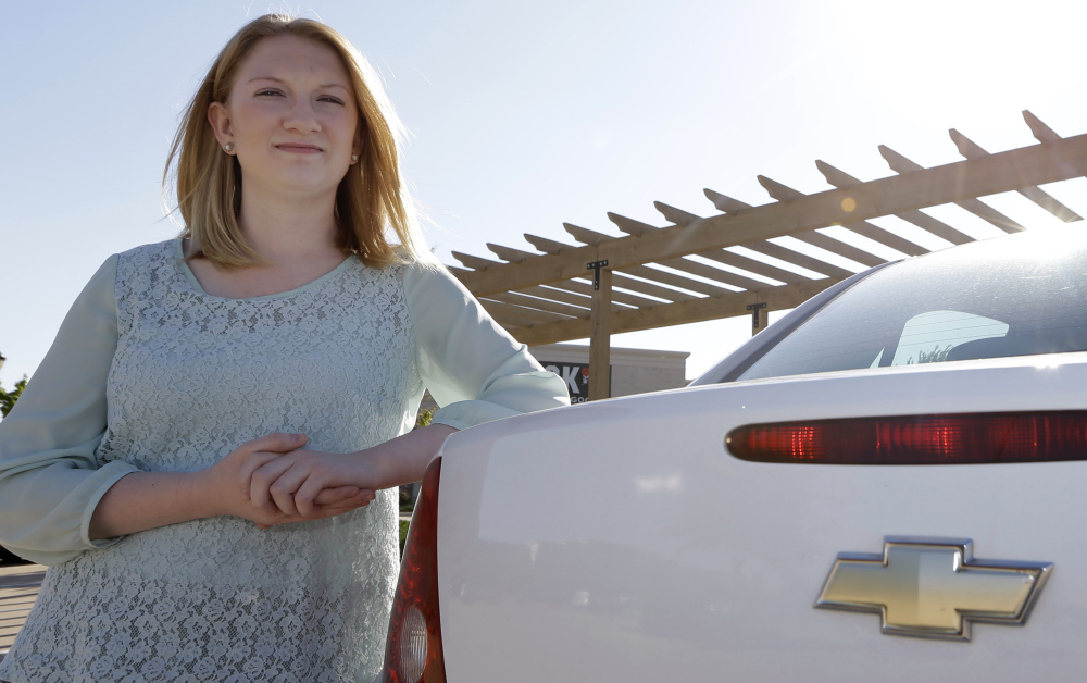 Wendi Kunkel leans her 2010 Chevy Cobalt in Rockwall, Texas, on April 18. She was instructed by her dealer to pull everything off her key ring to stop the ignition switch from turning off unexpectedly, but she’s still nervous about driving her car.