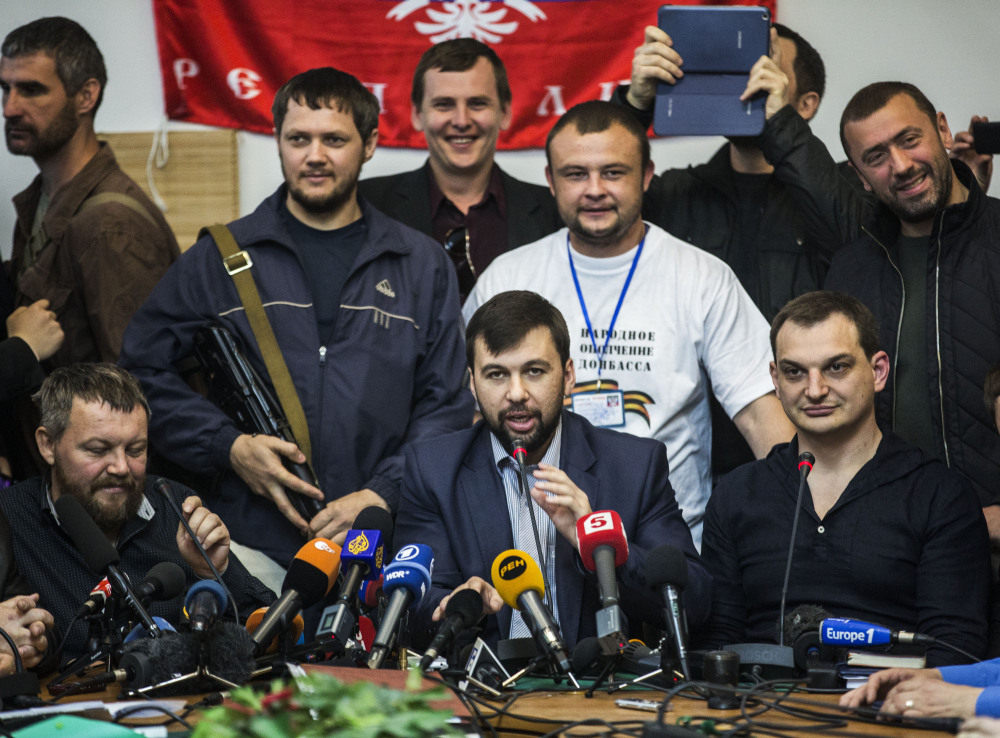 Denis Pushilin, center foreground, who heads the elections commission of the pro-Russian group that calls itself Donetsk People’s Republic, speaks Thursday about the upcoming referendum to be held in eastern Ukraine. The news conference was held in the occupied administration building in Donetsk, Ukraine.