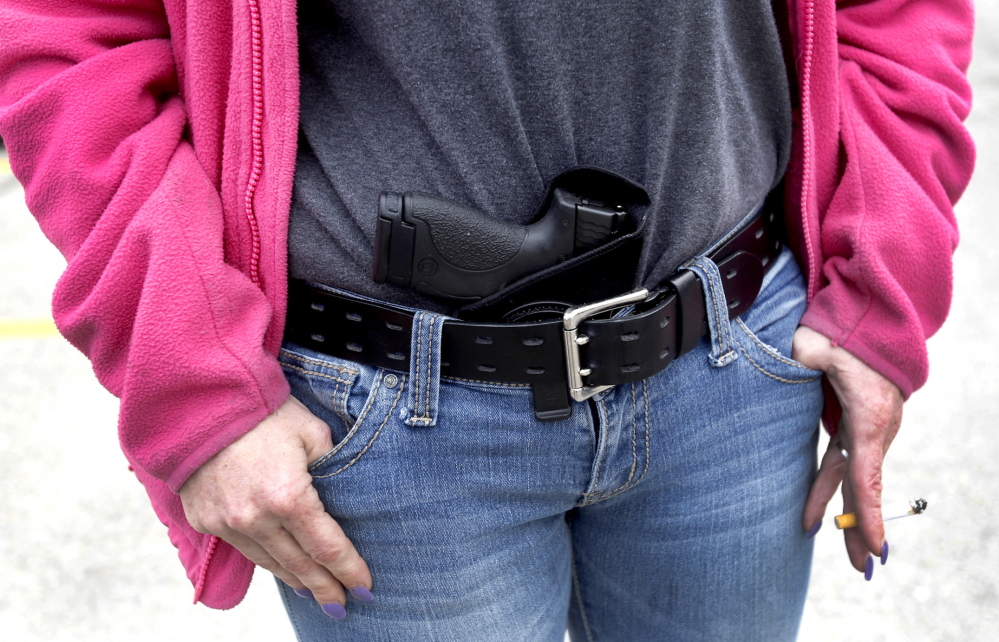 A woman carries 9 mm Smith & Wesson pistol in her waist band. Even lawmakers who support bills to permit guns in more places are mostly against allowing them in their own workplaces.